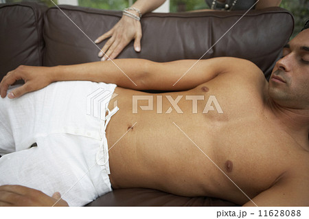 Man with bare chest sleeping on sofa Man with bare chest sleeping on sofa 11628088