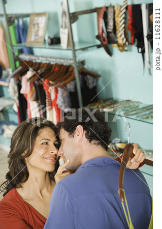 Hispanic couple shopping in clothing store 11628111
