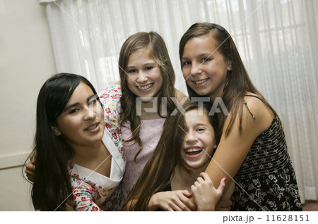 Multi-ethnic girls hugging 11628151