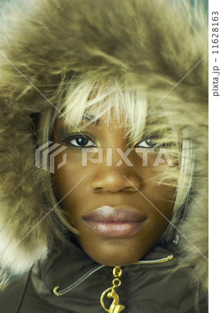 African woman wearing coat with fur hood 11628163