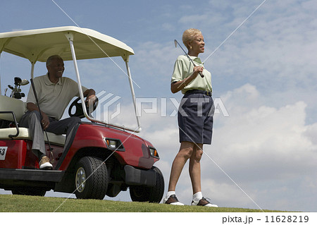 Senior African American couple with golf cart 11628219