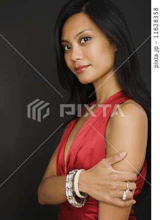 Pacific Islander woman wearing diamond jewelry 11628358