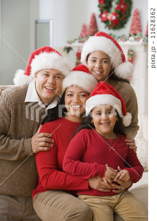 Hispanic family wearing Santa Claus hats 11628362