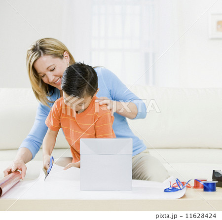 Mother and son wrapping gift 11628424