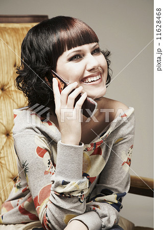 Mixed Race woman talking on cell phone 11628468