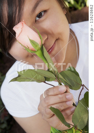 Asian woman holding flower 11628662