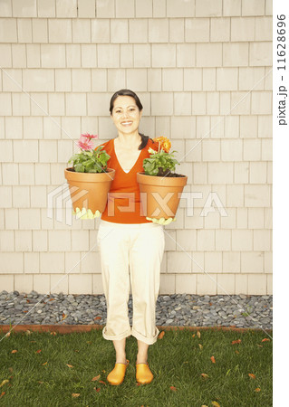 Asian woman holding potted plants 11628696