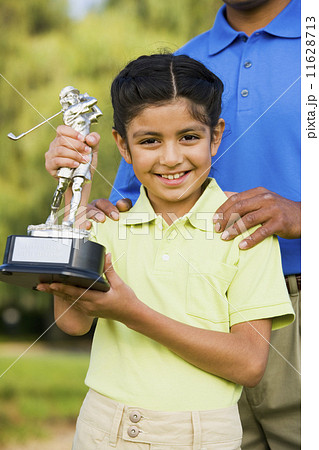 Hispanic girl holding golf trophy Hispanic girl holding golf trophy 11628713