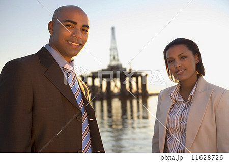 African American businesspeople in front of shipping crane 11628726