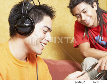Two Hispanic men looking at cds 11628808