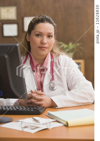 Hispanic female doctor at desk Hispanic female doctor at desk 11628830