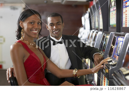 Couple next to slot machines Couple next to slot machines 11628867