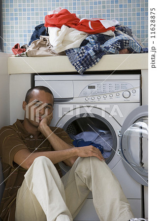 Young man doing laundry 11628875