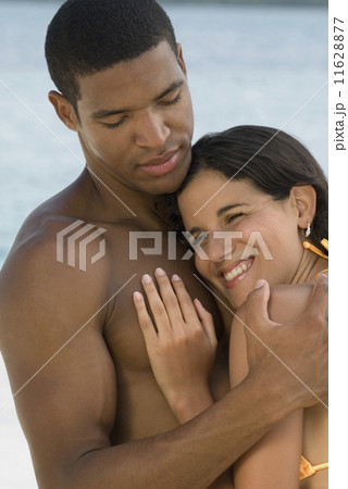 Hispanic couple hugging 11628877