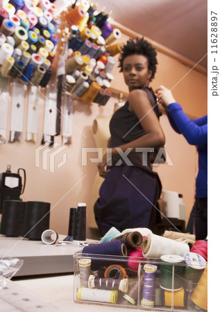 African woman trying on dress at seamstress shop 11628897