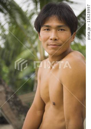 Close up of bare-chested Asian man 11628997