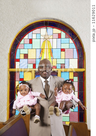 African American father holding babies in church African American father holding babies in church 11629011