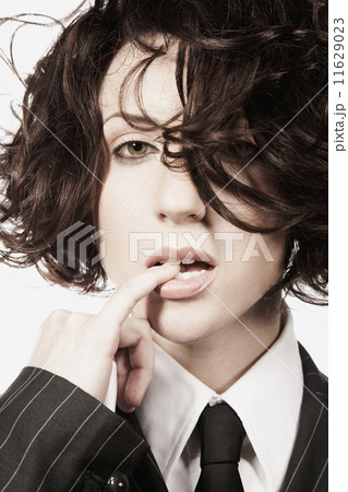 Close up of woman biting finger 11629023