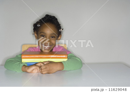 African girl with stack of school books 11629048
