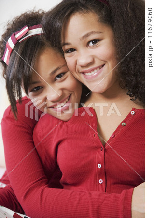 African twin sisters hugging African twin sisters hugging 11629060