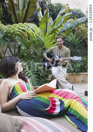 Multi-ethnic couple relaxing outdoors 11629064