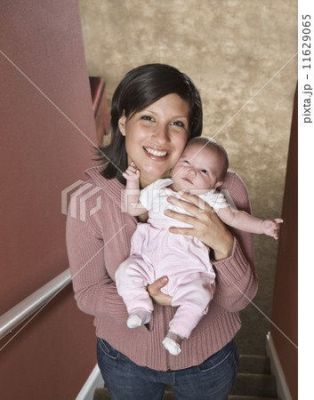 Hispanic mother holding baby 11629065