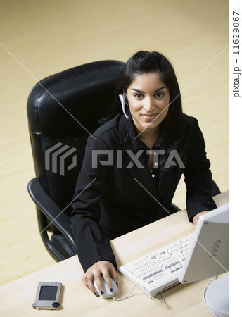 Indian businesswoman wearing headset Indian businesswoman wearing headset 11629067