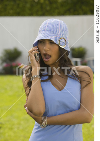 Hispanic woman talking on cell phone 11629087