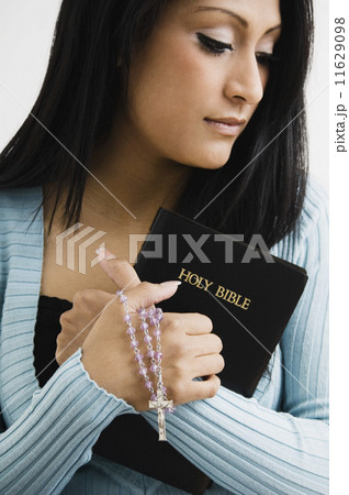 Hispanic woman holding bible 11629098