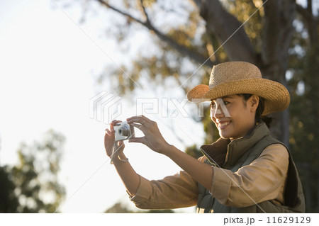 Asian woman taking photograph 11629129