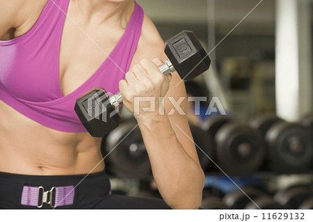 Woman lifting weights 11629132