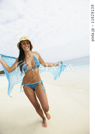 South American woman walking on beach 11629139