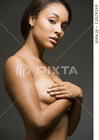 Nude Hispanic woman with arms covering breasts 11629149