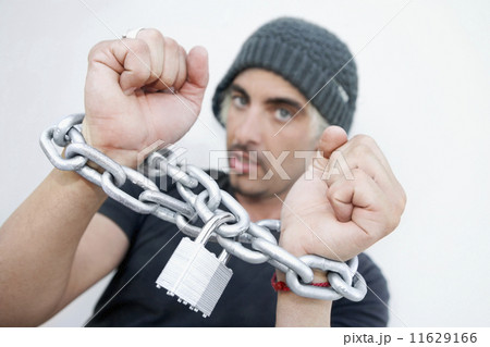 Hispanic man with chains around wrists 11629166