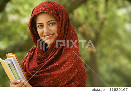 Indian woman holding school books 11629167