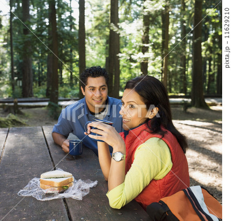Indian couple eating lunch in woods 11629210