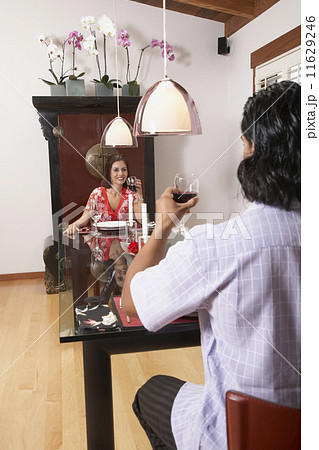 Multi-ethnic couple eating dinner 11629246