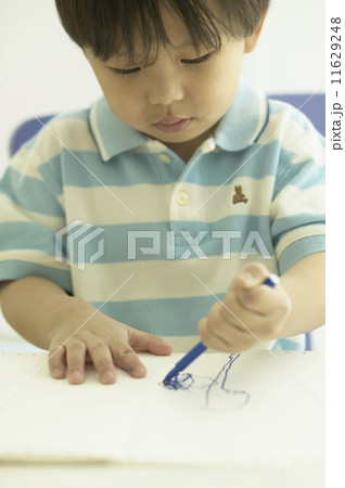 Close up of young Asian boy drawing 11629248