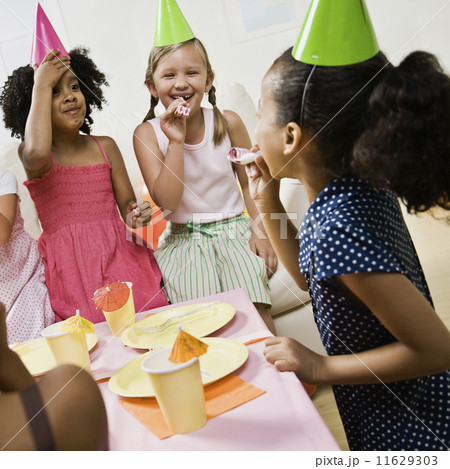 Multi-ethnic girls playing at party Multi-ethnic girls playing at party 11629303