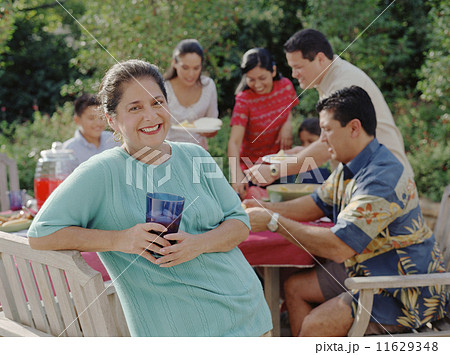 Middle-aged woman smiling for the camera at a barbecue 11629348