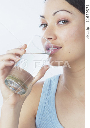 Young woman drinking glass of water 11629371