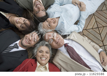 Hispanic businesspeople laying on floor 11629386