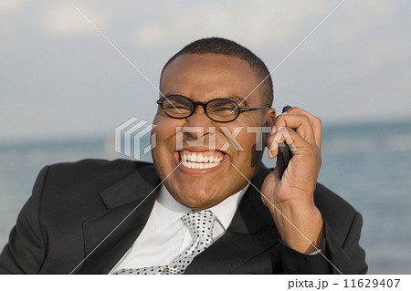 African businessman talking on cell phone African businessman talking on cell phone 11629407