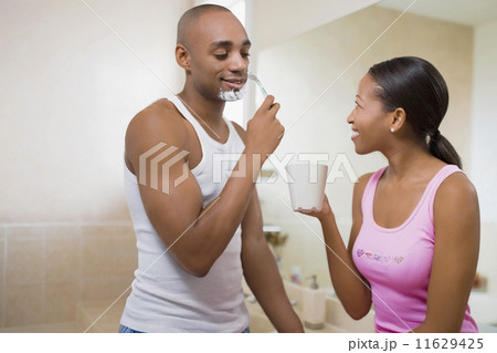 African woman watching husband shave 11629425