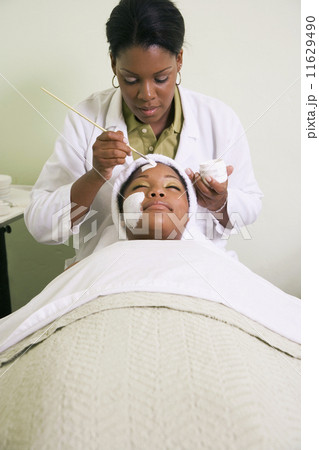 African woman receiving spa facial treatment African woman receiving spa facial treatment 11629490