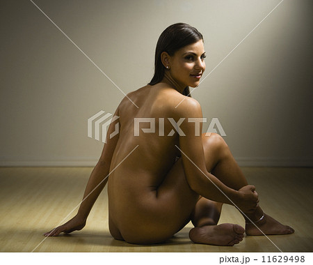 Nude woman sitting on floor 11629498