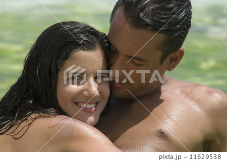 Hispanic couple hugging 11629538