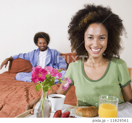 African woman carrying breakfast in bed tray 11629561