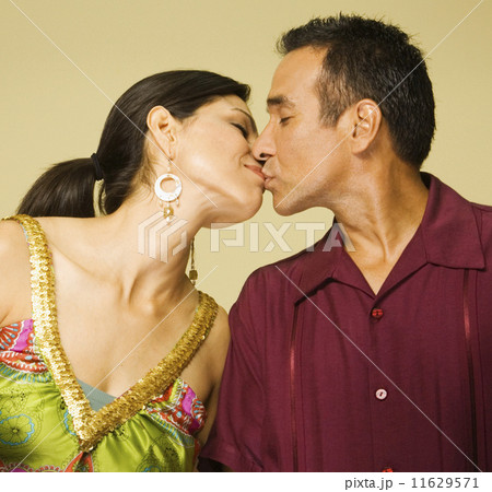 Studio shot of Hispanic couple kissing Studio shot of Hispanic couple kissing 11629571