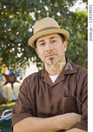 Hispanic man with arms crossed Hispanic man with arms crossed 11629601